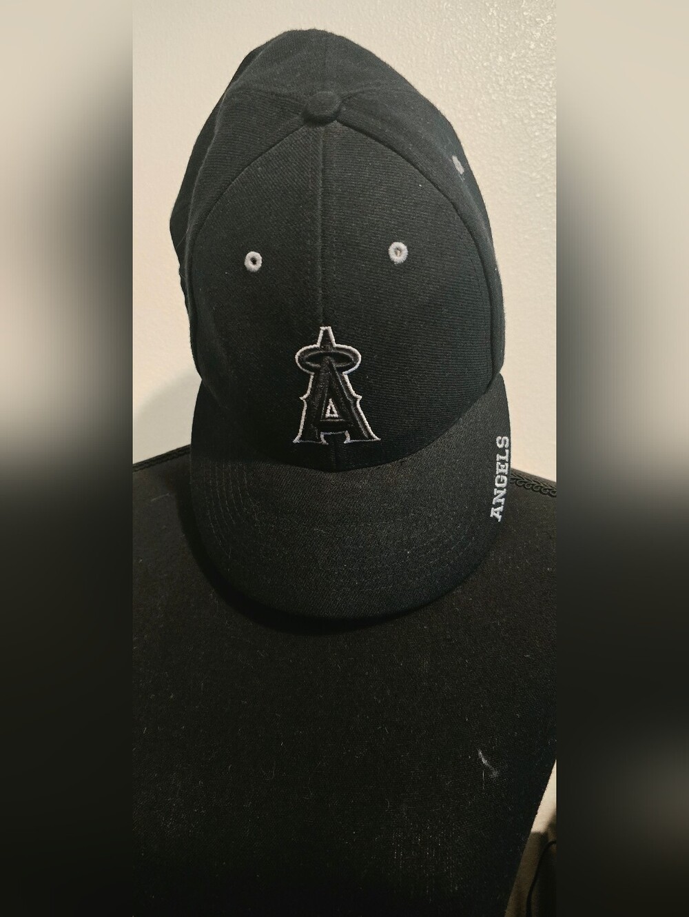 Genuine Merchandise Black Baseball Cap with White Eyelets